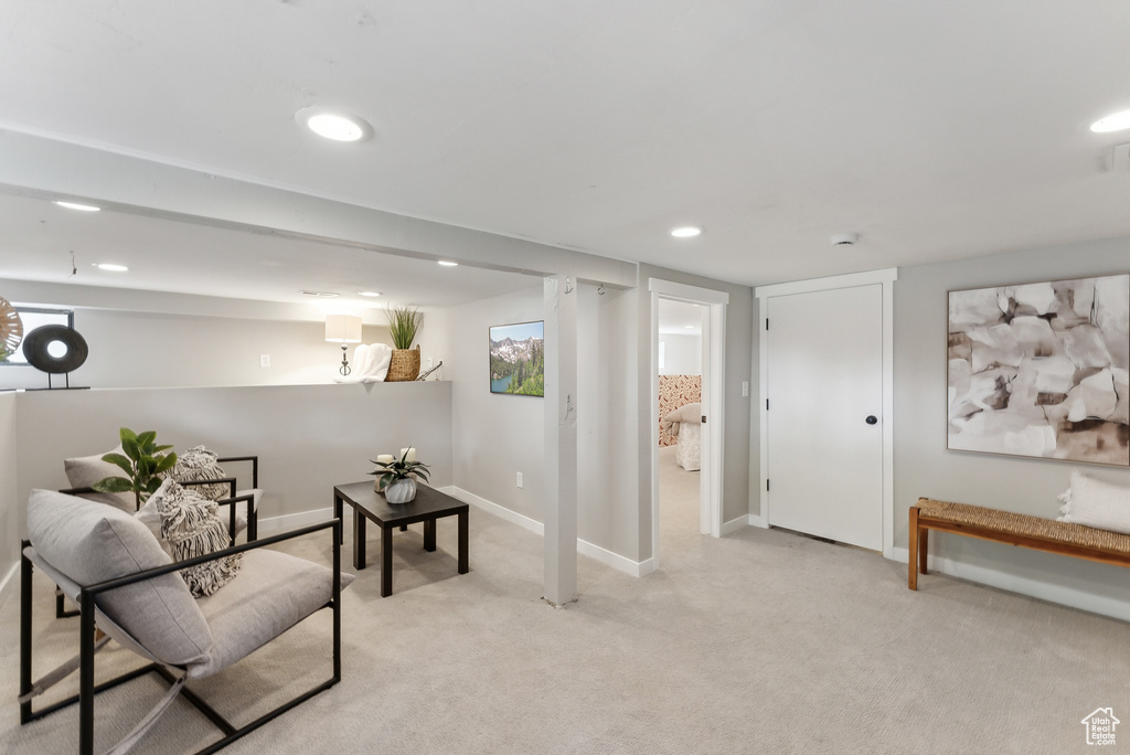 Living area featuring light carpet, baseboards, visible vents, and recessed lighting