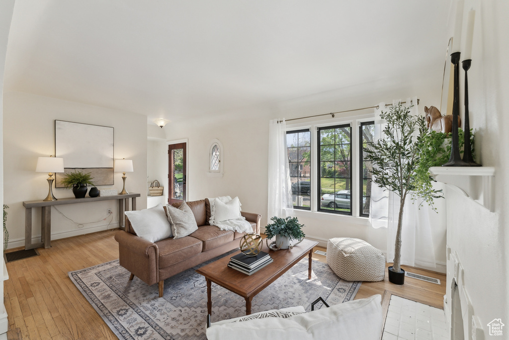 Living room with light wood finished floors and visible vents