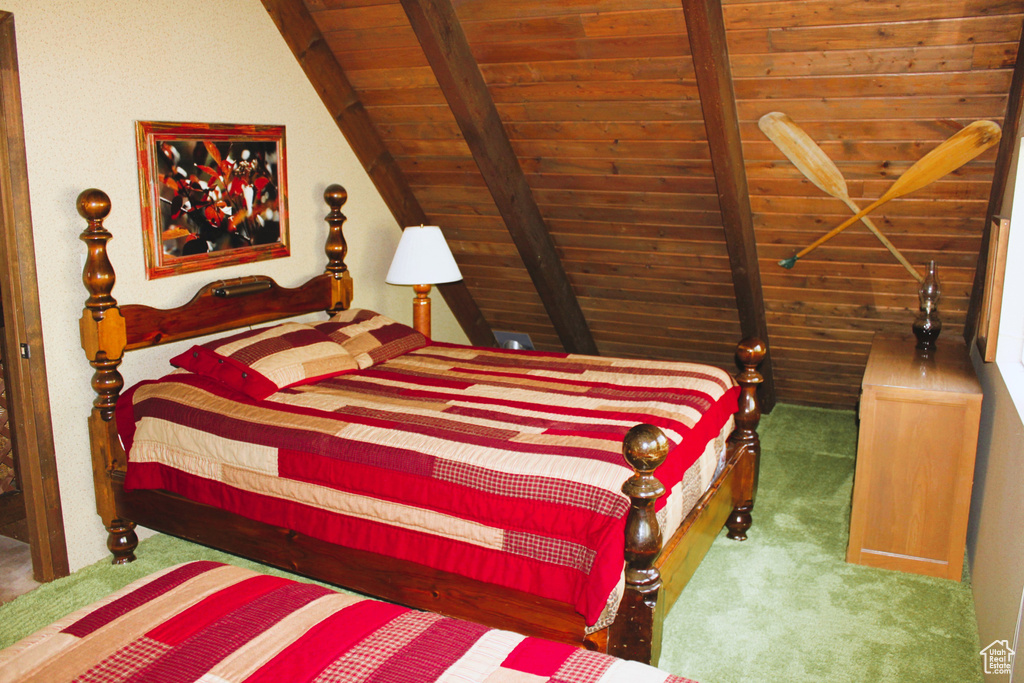 Carpeted bedroom featuring wood ceiling