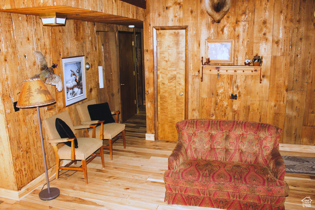 Living area featuring wooden walls and hardwood / wood-style floors