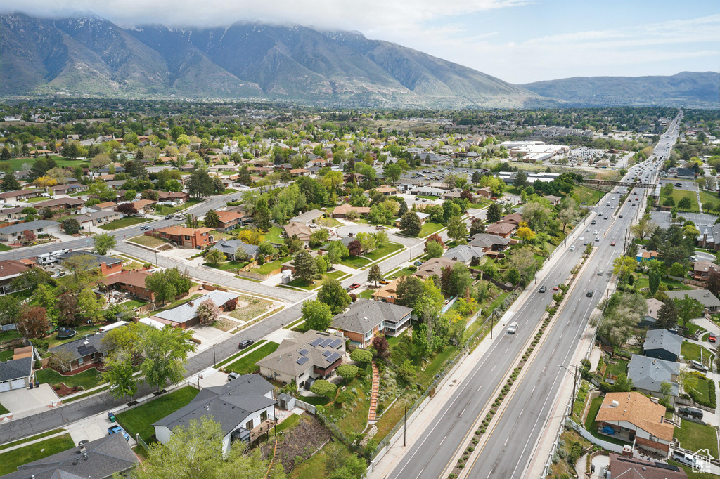 Aerial overview of property\'s location featuring a major roadway, a mountainous background, and nearby suburban area