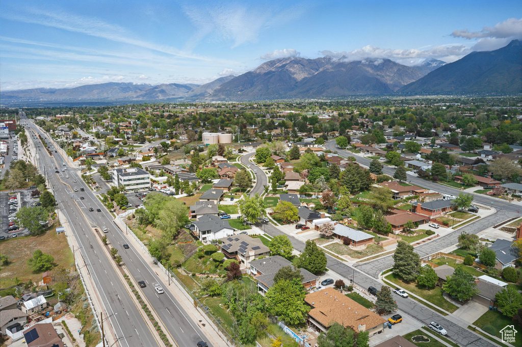 Aerial perspective of suburban area with a main thoroughfare and mountains