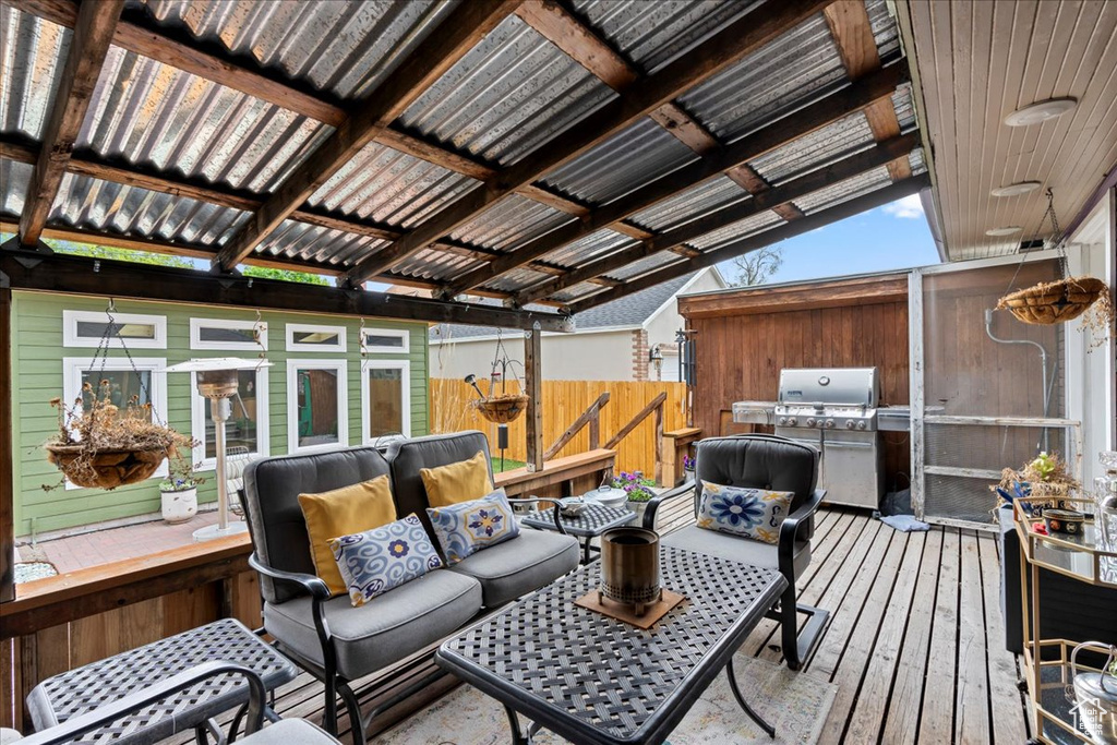 Wooden deck with an outdoor hangout area and fence