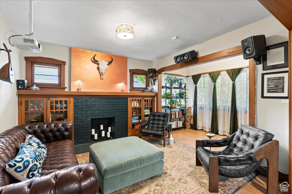 Living area featuring wood finished floors and a brick fireplace