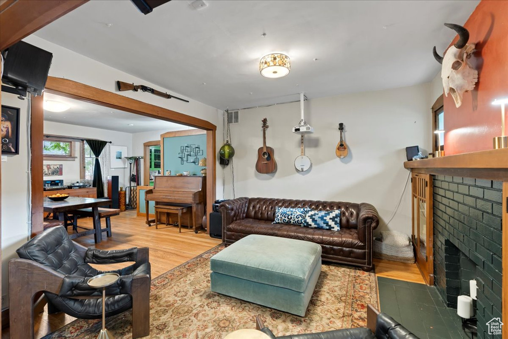 Living room with a fireplace and wood finished floors