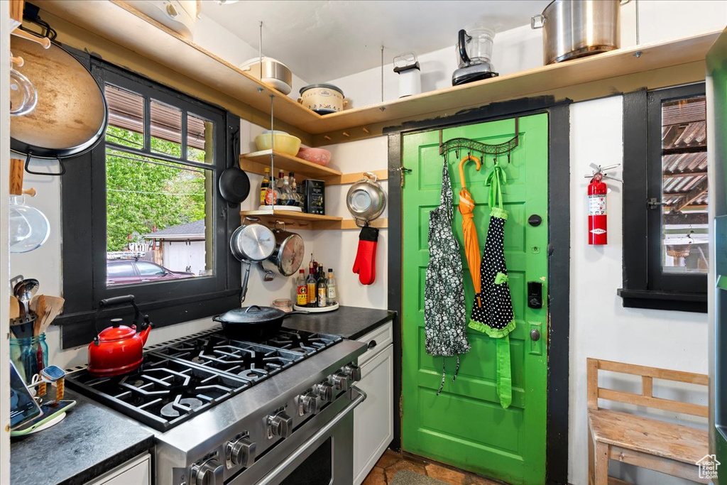 Kitchen with dark countertops and high end range