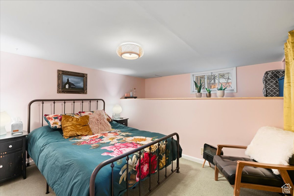 Bedroom with baseboards and light colored carpet