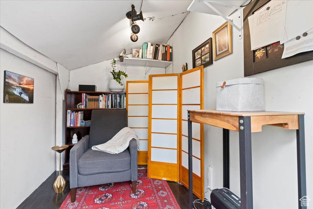 Living area featuring vaulted ceiling and wood finished floors