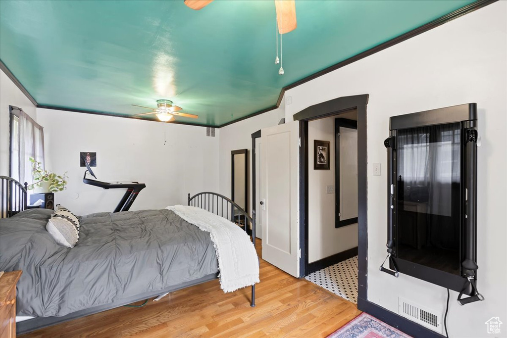 Bedroom featuring light wood-style flooring, a ceiling fan, and visible vents