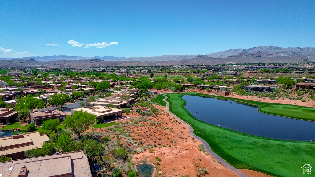 Aerial view with view of golf course, a residential view, and a water and mountain view