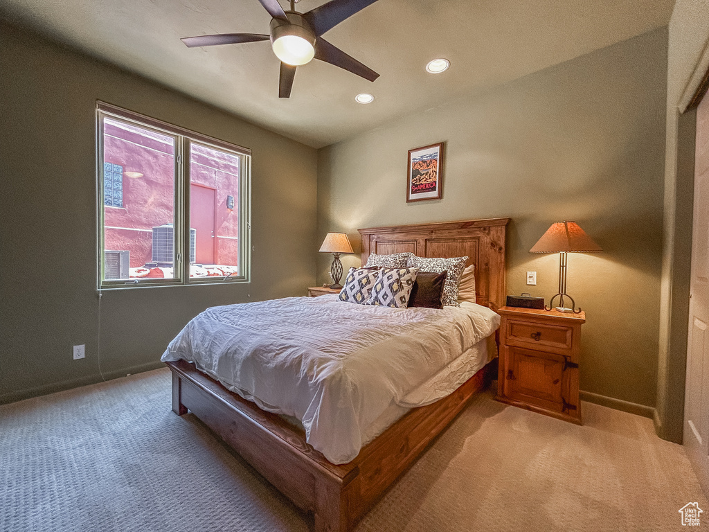 Bedroom with light colored carpet, baseboards, a ceiling fan, and recessed lighting