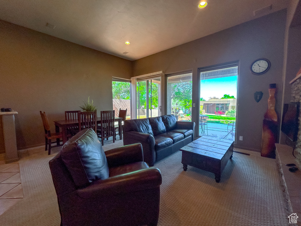 Living area featuring light tile patterned floors, baseboards, and recessed lighting