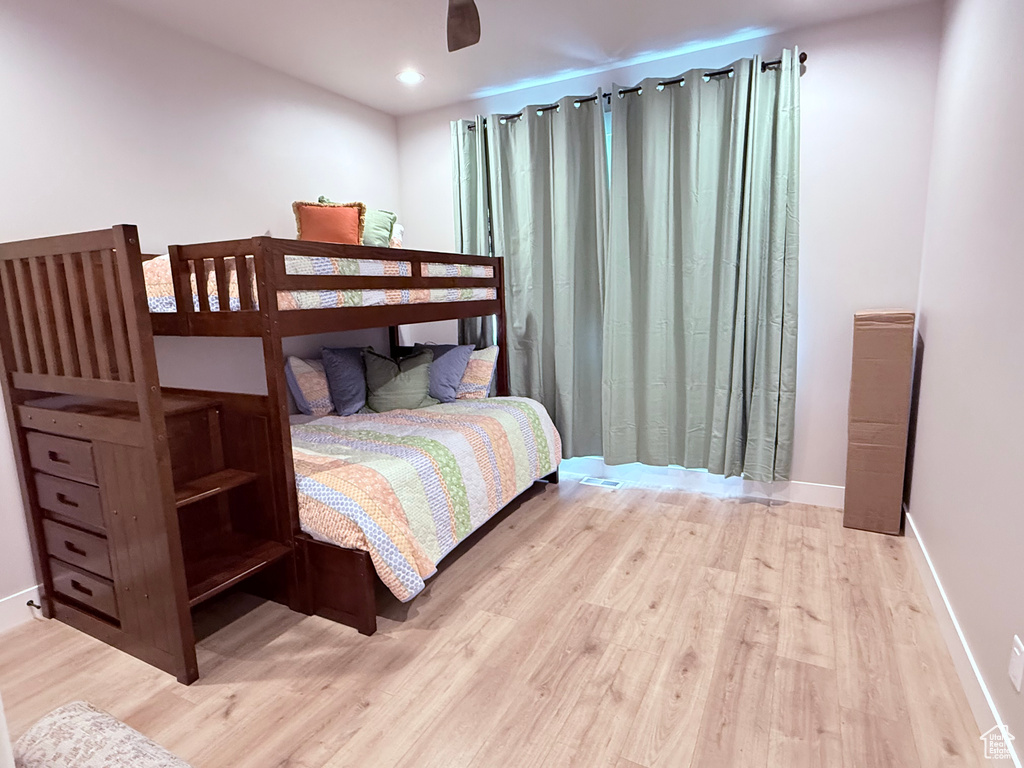 Bedroom with light wood finished floors and baseboards