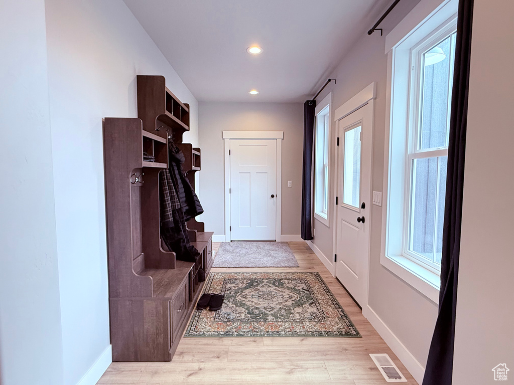 Mudroom with baseboards, light wood-type flooring, and recessed lighting
