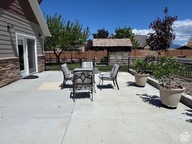View of patio featuring fence