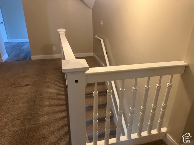 Staircase with carpet floors and baseboards