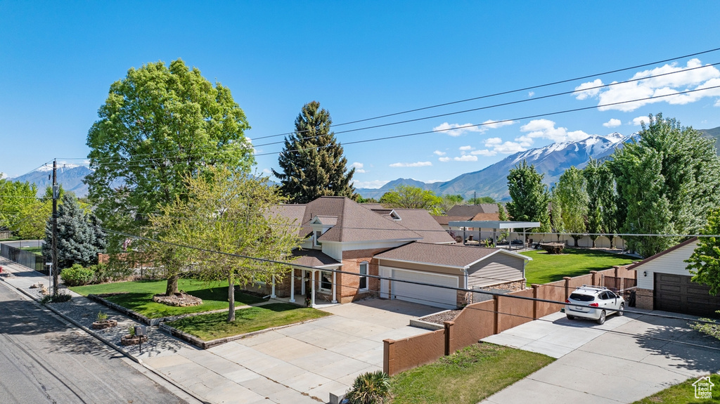 View of front of house with driveway and a mountain view