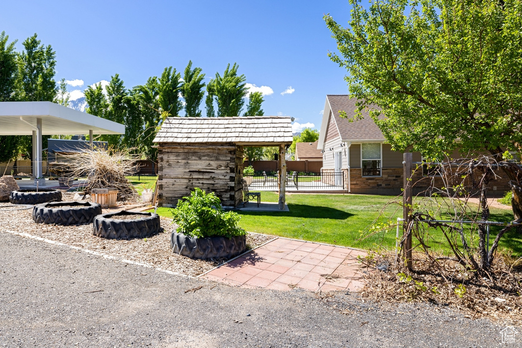 View of yard featuring a fire pit and an outdoor structure