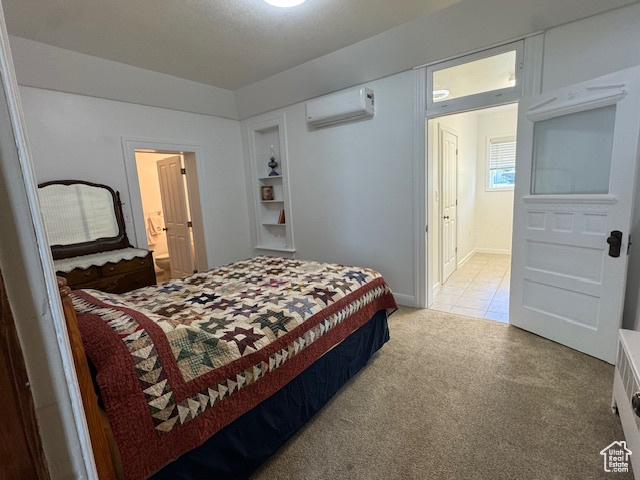 Bedroom featuring a wall unit AC, light carpet, and connected bathroom