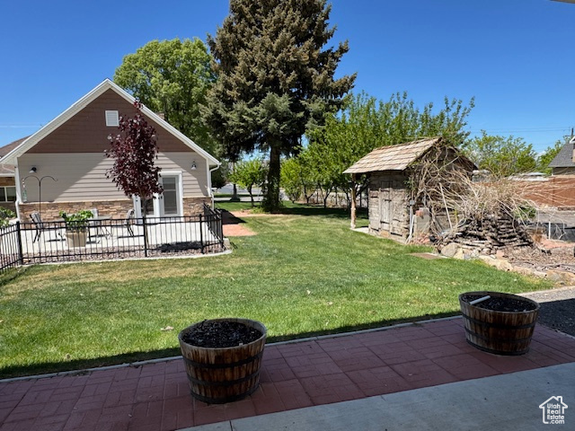View of yard with a patio and an outdoor structure