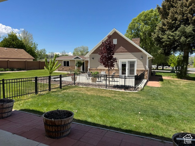 Back of house with a patio area and a chimney