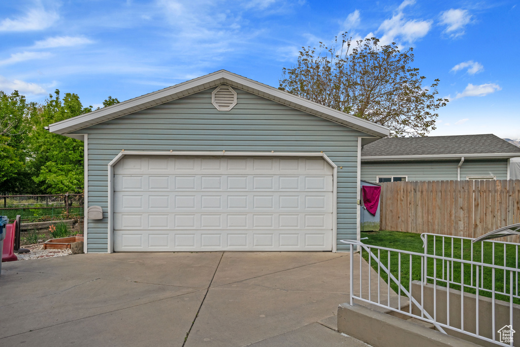 Garage featuring fence