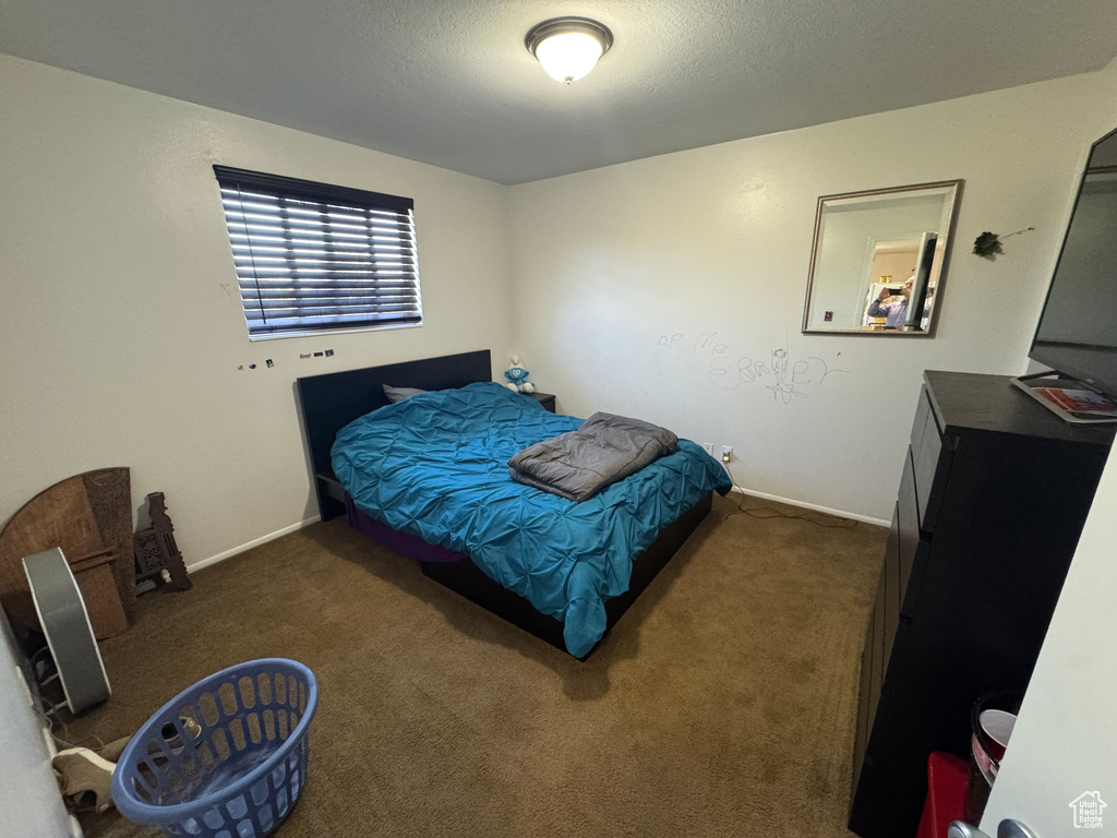 Bedroom featuring carpet floors and baseboards