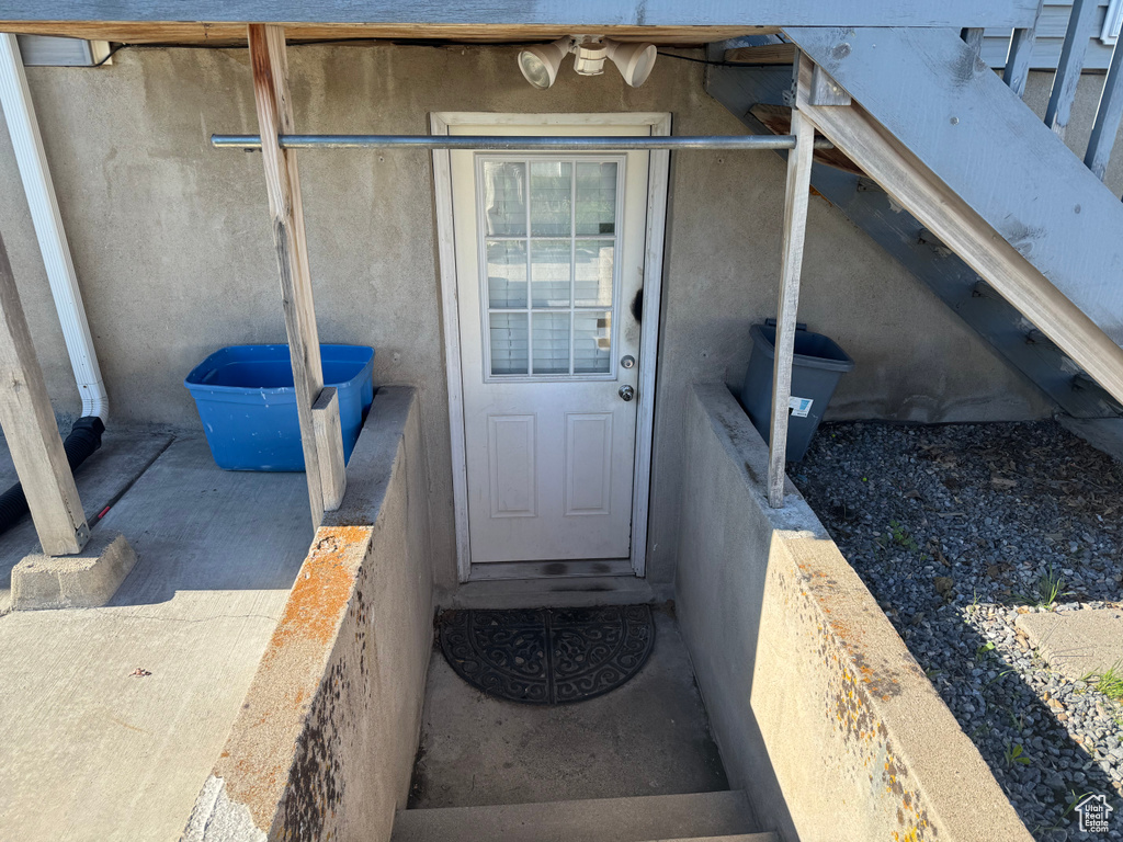 View of exterior entry featuring stucco siding