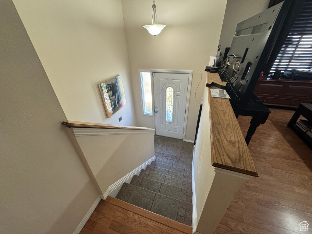 Entrance foyer featuring baseboards and a high ceiling