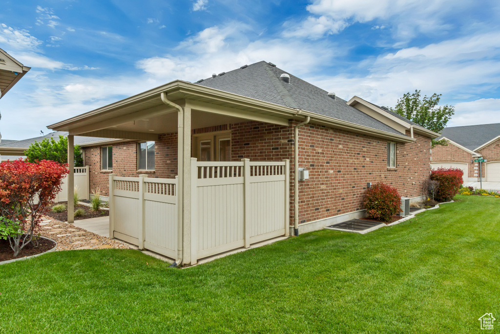View of side of property with brick siding and roof with shingles
