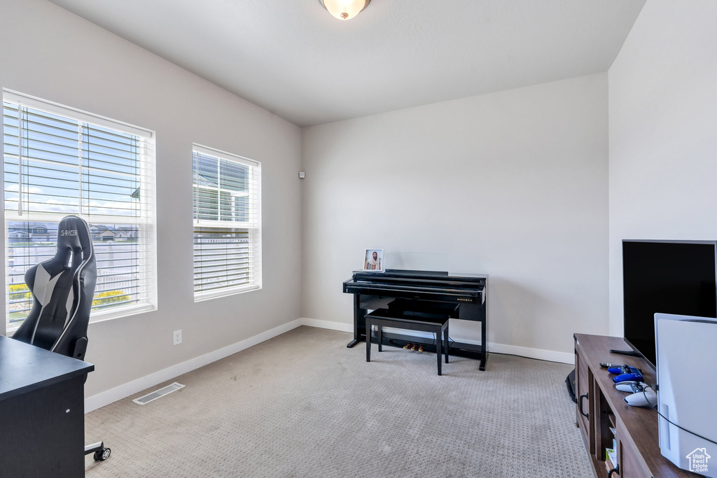 Carpeted office space featuring baseboards