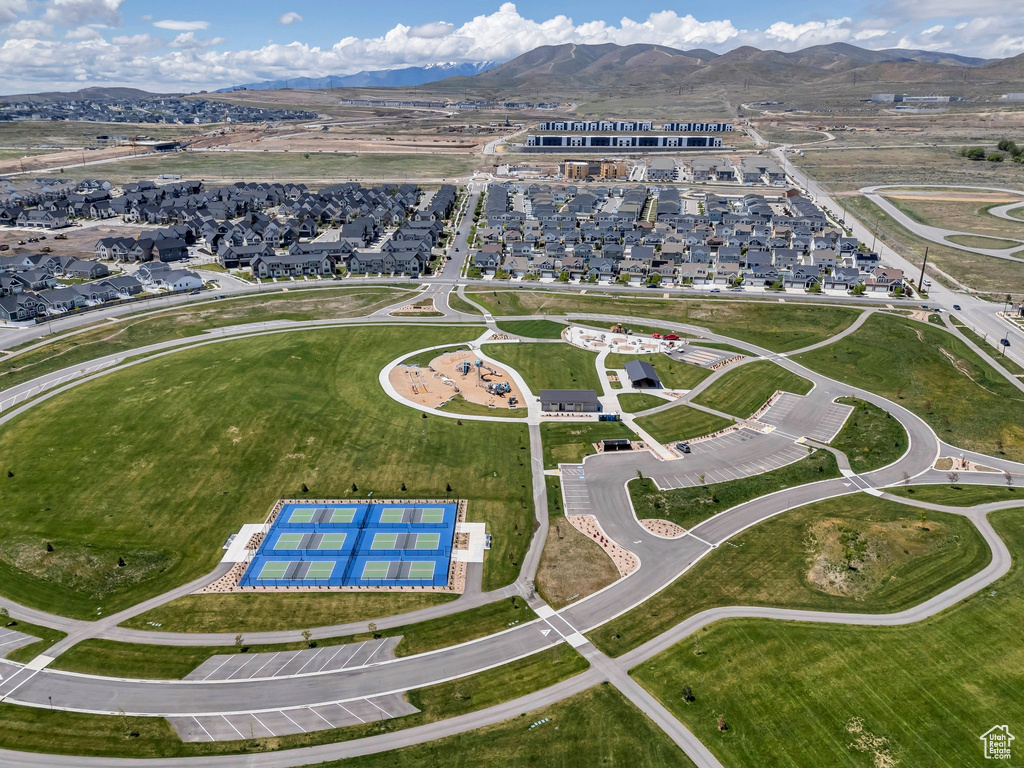 Aerial view of property and surrounding area with mountains and nearby suburban area