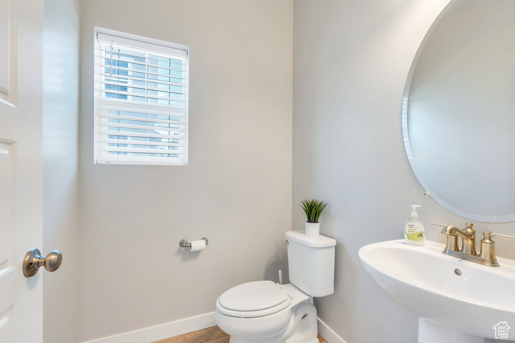 Bathroom with a sink, baseboards, and toilet