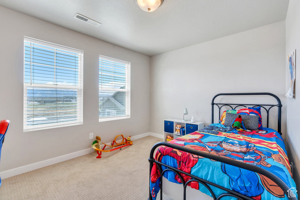 Carpeted bedroom with baseboards