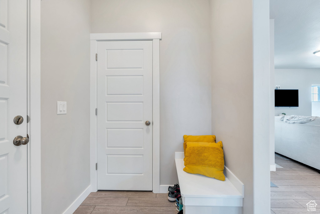 Living area with light wood-style flooring and baseboards