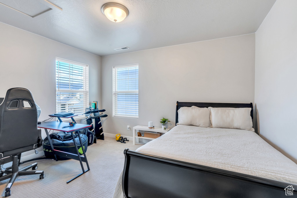 Carpeted bedroom featuring baseboards