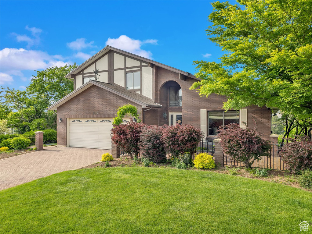 View of front facade featuring brick siding and driveway