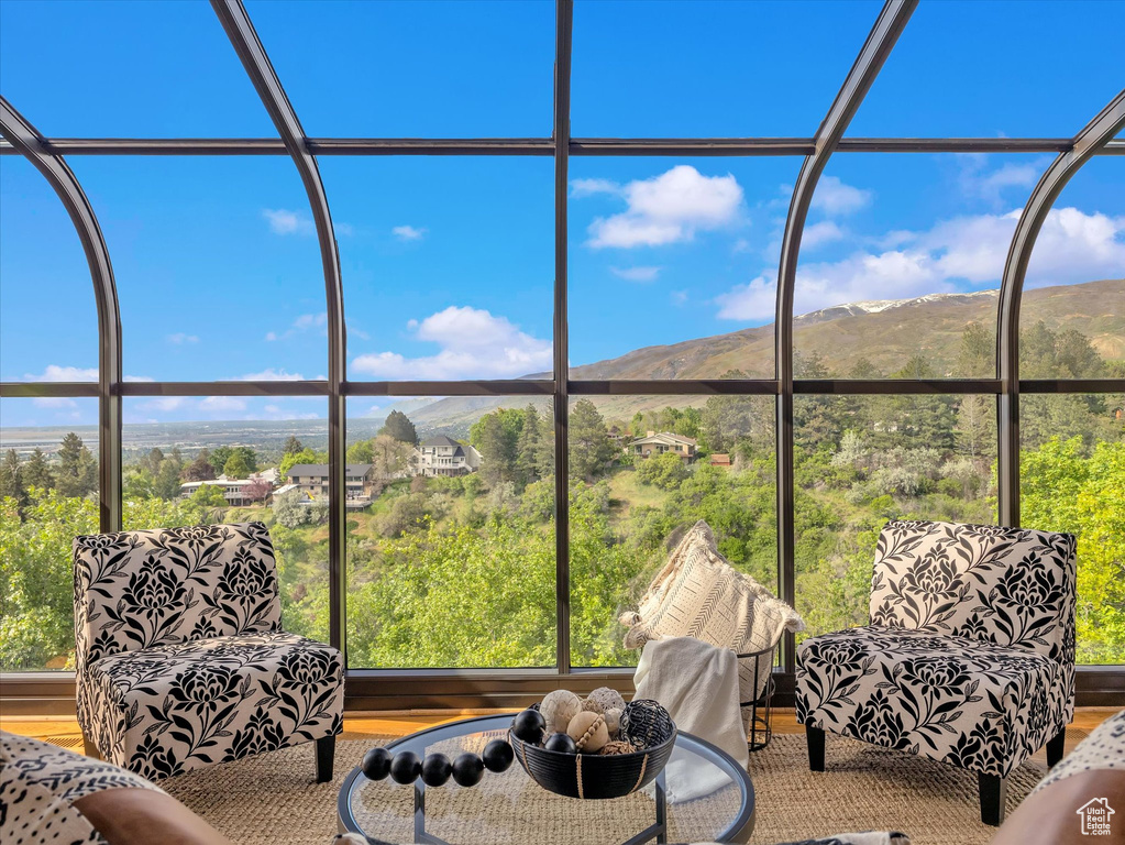Sunroom / solarium featuring a mountain view