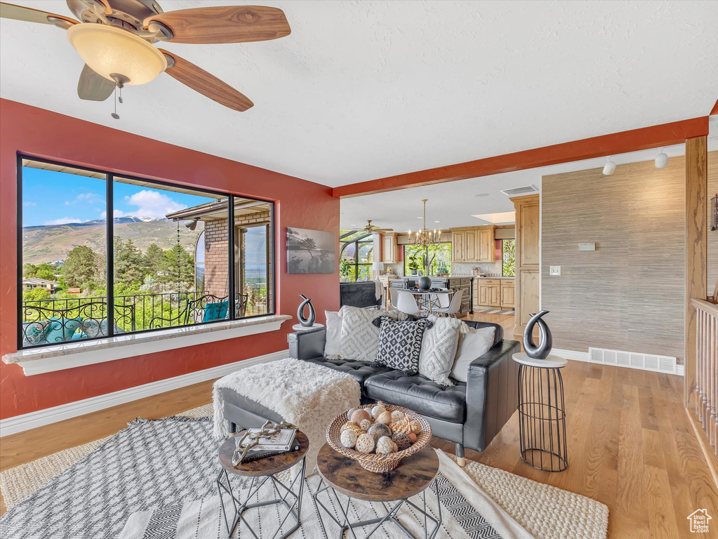 Living area featuring baseboards and plenty of natural light