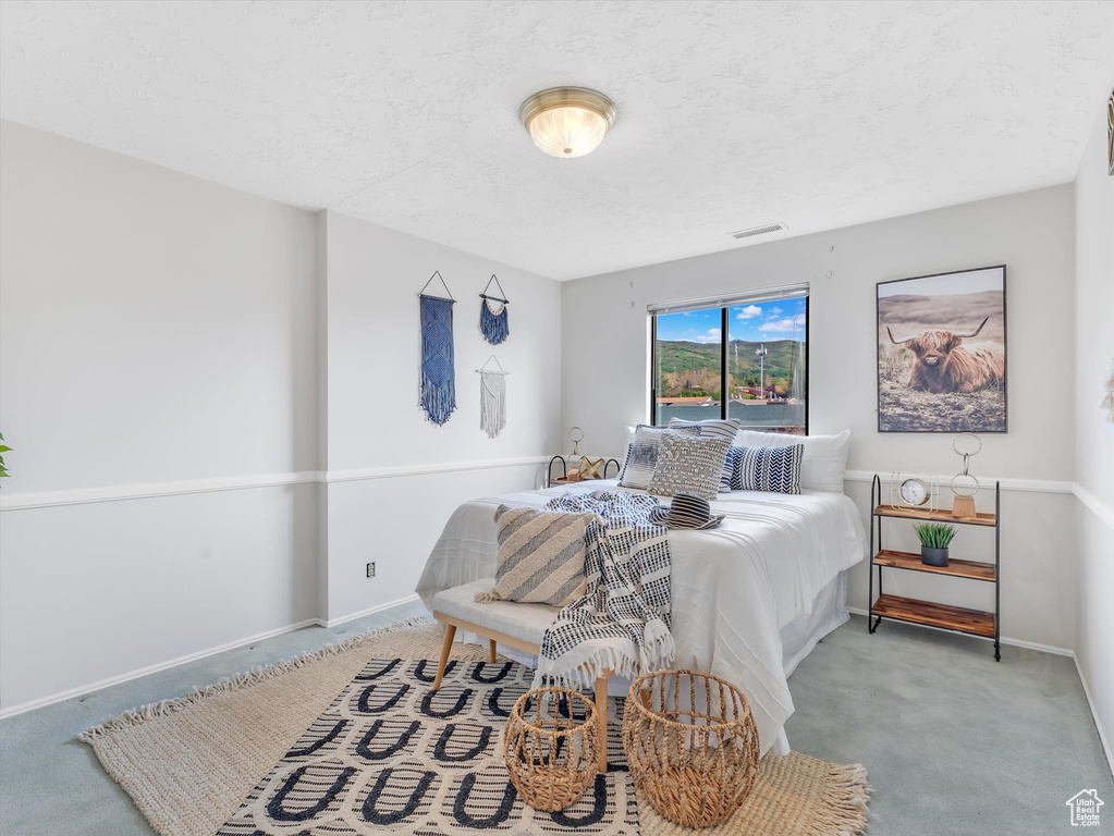 Carpeted bedroom with baseboards