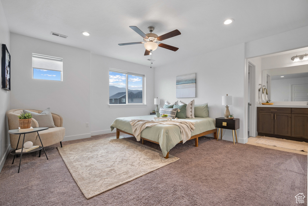 Bedroom featuring light colored carpet, recessed lighting, a ceiling fan, baseboards, and ensuite bathroom