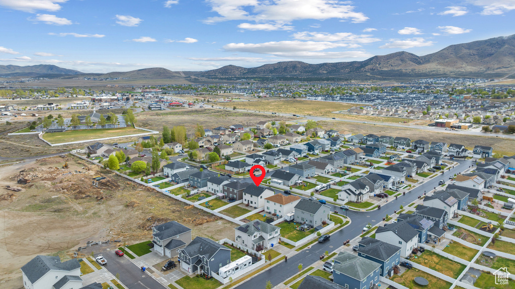 Aerial overview of property\\\'s location with a mountain backdrop and nearby suburban area
