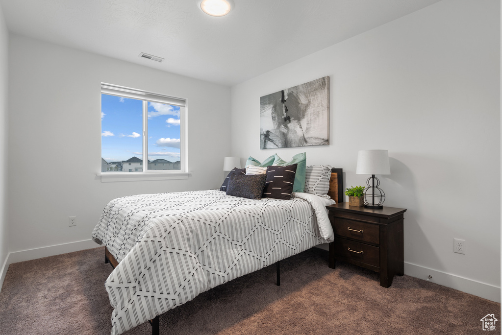 Carpeted bedroom with baseboards