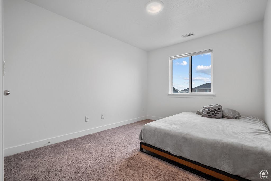 Carpeted bedroom featuring baseboards