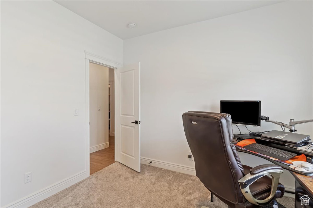 Carpeted office space with baseboards