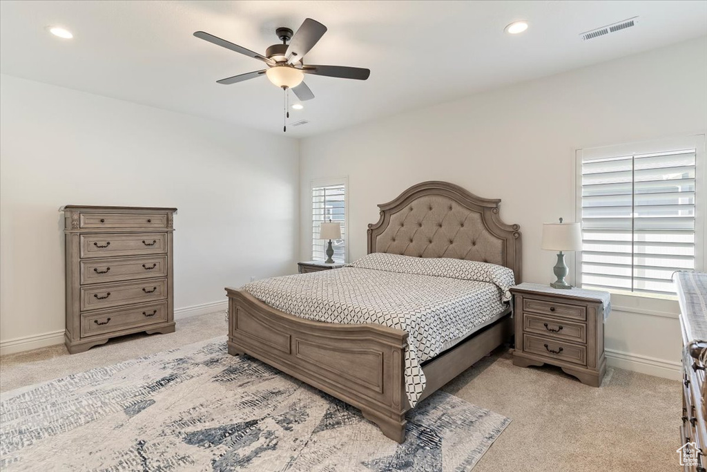 Bedroom with light carpet, baseboards, recessed lighting, and ceiling fan