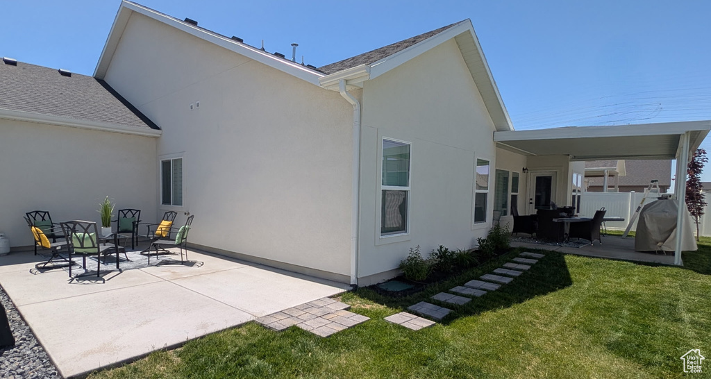 Rear view of property featuring a patio area and stucco siding