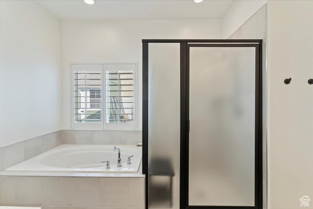 Bathroom with a garden tub and a stall shower