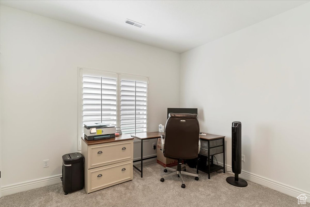 Office with light carpet and baseboards
