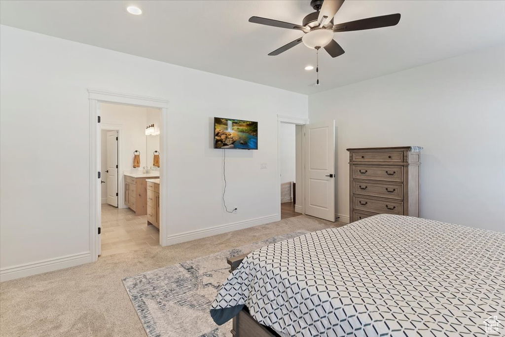 Bedroom featuring light carpet, recessed lighting, baseboards, ensuite bathroom, and a ceiling fan